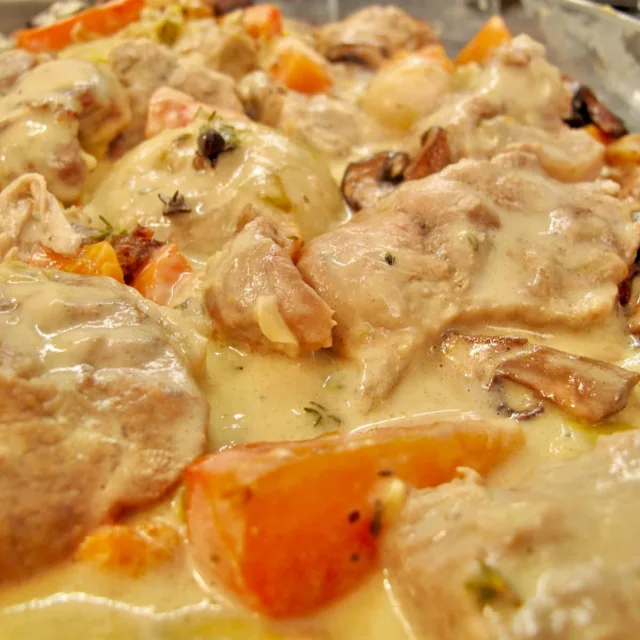 tender veal in a white sauce with vegetables known as a French Blanquette de Veau stew