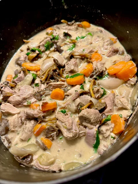 large casserole dish with a veal stew, best known as Blanquette as the meat is cooked without browning in white wine and vegetables and finished with a creamy sauce