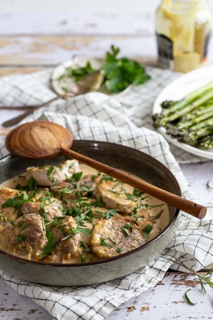 Pork tenderloin medallions in mustard cream sauce with herbs.
