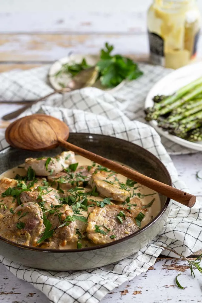 Pork tenderloin medallions in mustard cream sauce with herbs.
