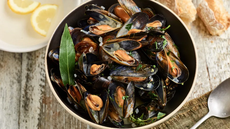 Moules marinière with parsley and wine broth.