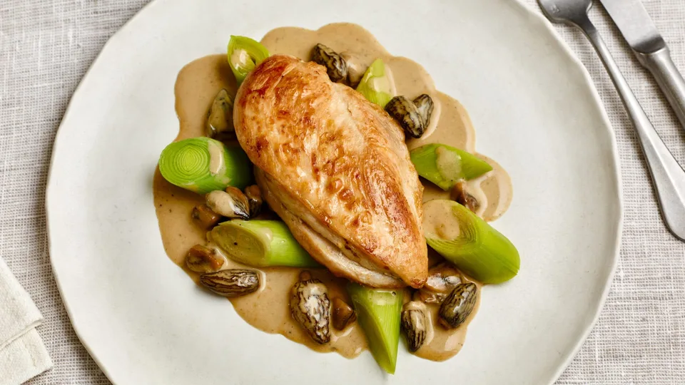 Chicken breast with morel cream sauce and leeks.